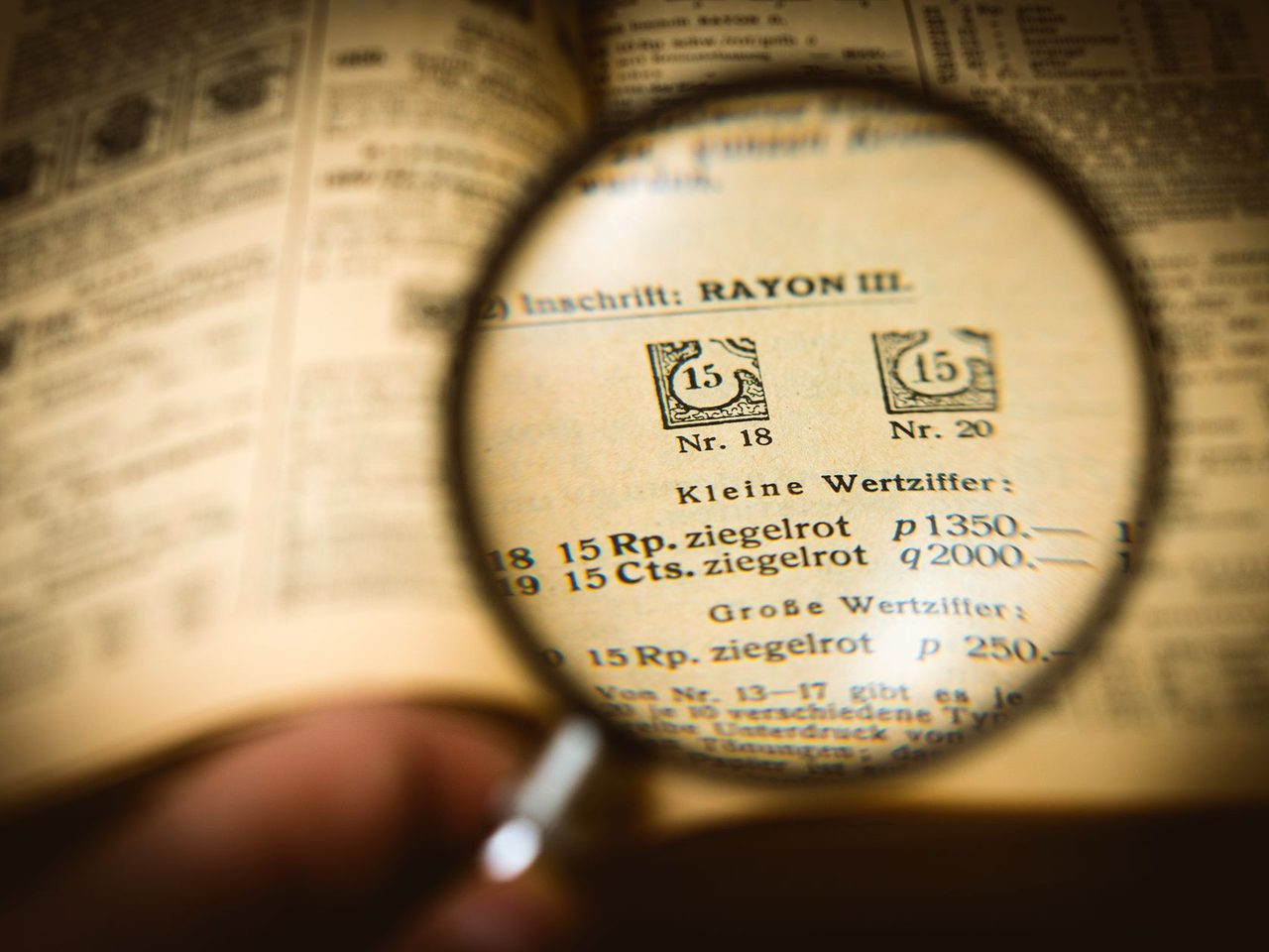A magnifying glass enlarging the small print on an old printed page
